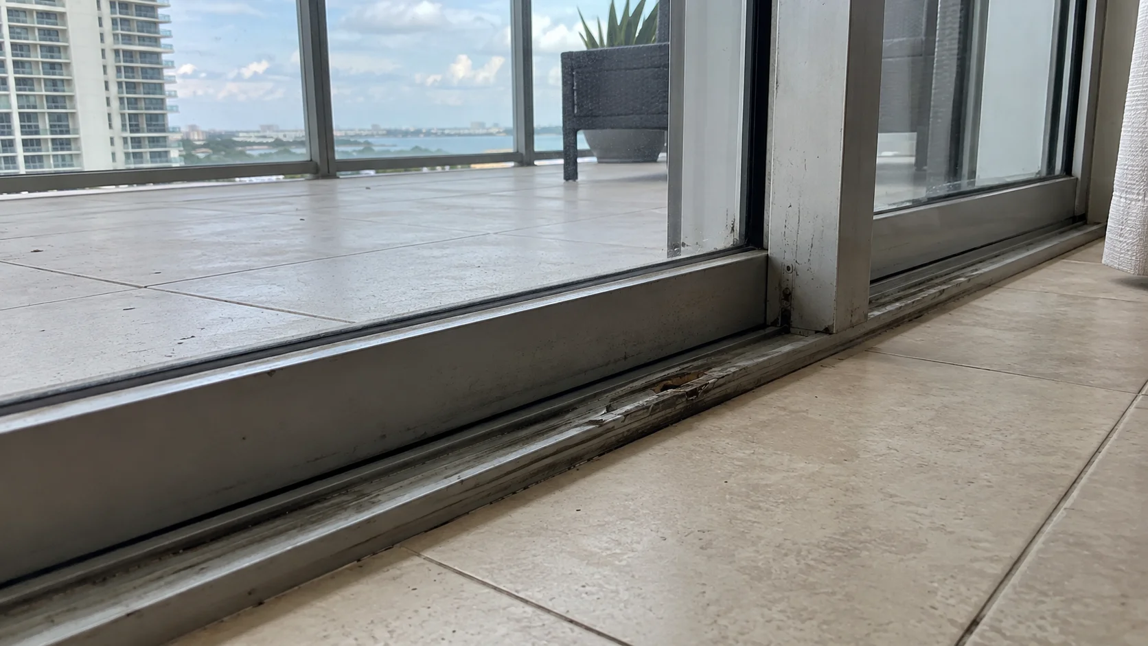 Sliding glass door track before repair