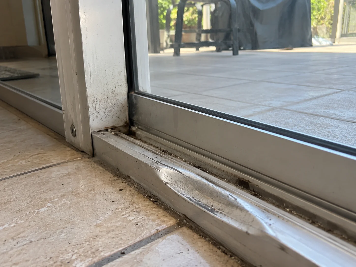 Bent and warped sliding door bottom track needing repair
