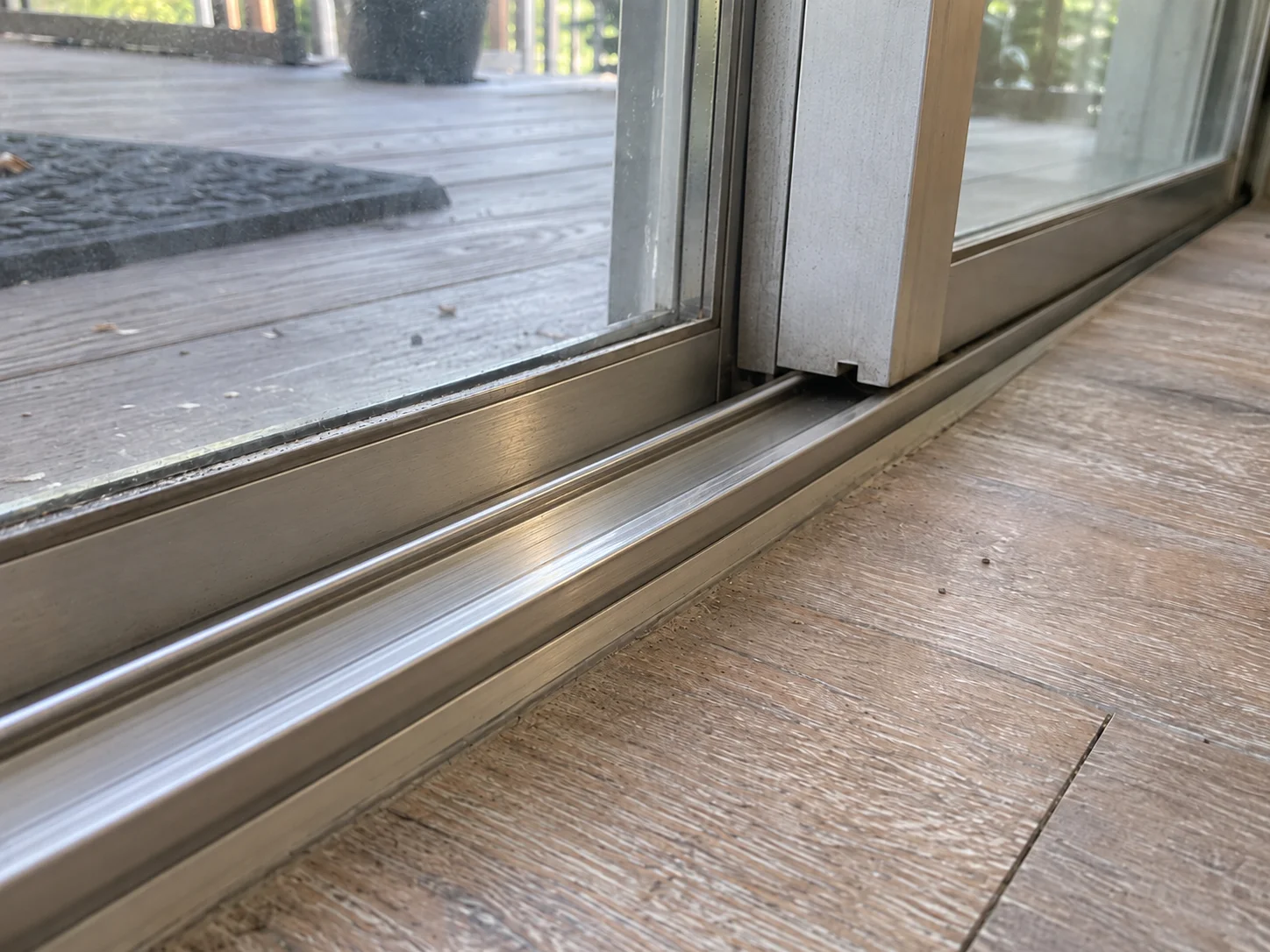 Sliding door frame corner inspected where the panel sags