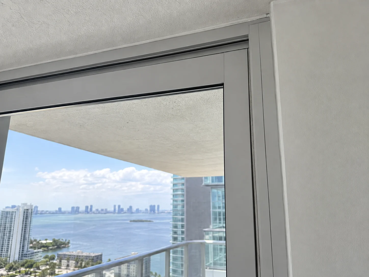 After: new sliding door frame with clean clear glass and ocean view